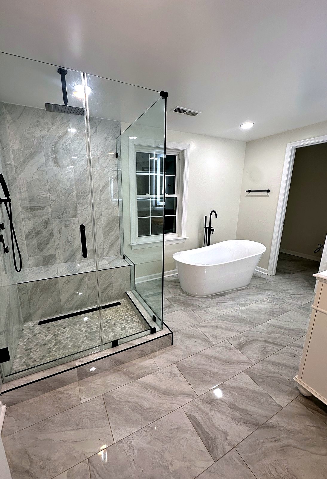 Glass walk-in shower with tiled bench and linear drain
