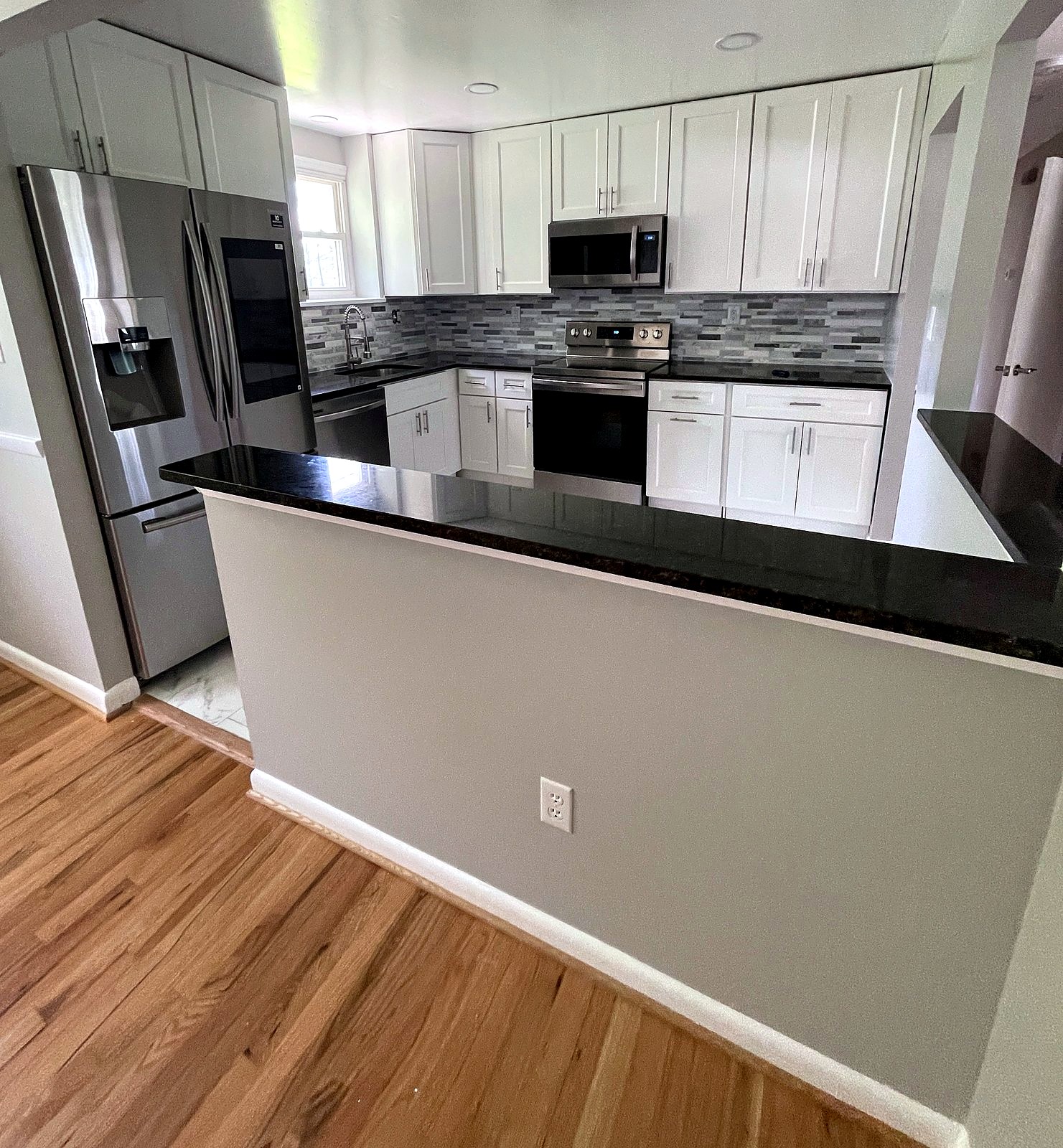Opened wall with granite peninsula