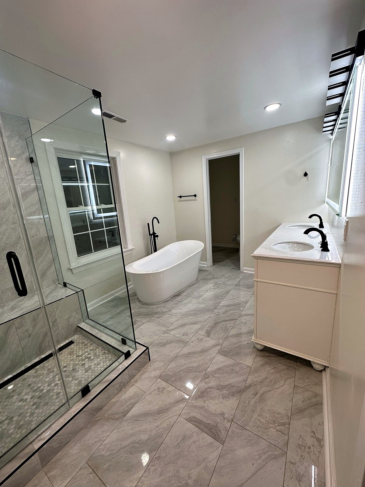 Primary bathroom with double vanity and matte black fixtures