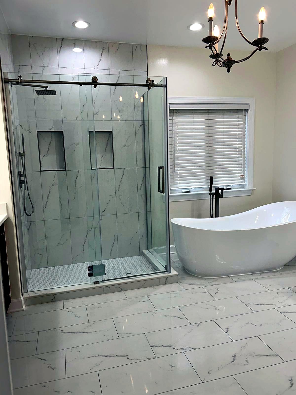 Primary bathroom with marble walk-in shower and freestanding tub